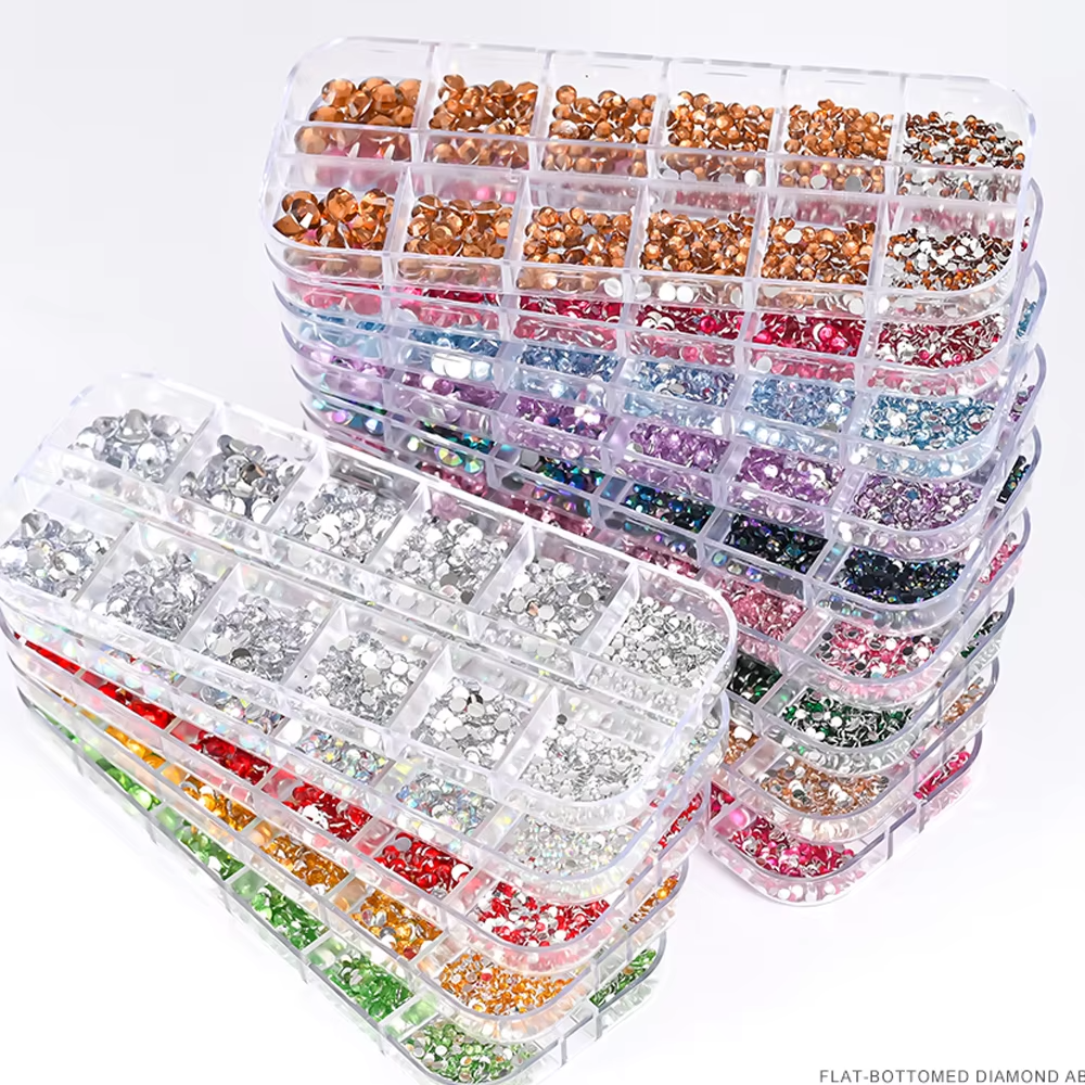 Plastic containers with various colored flat-bottomed diamond AB rhinestones organized by compartment.