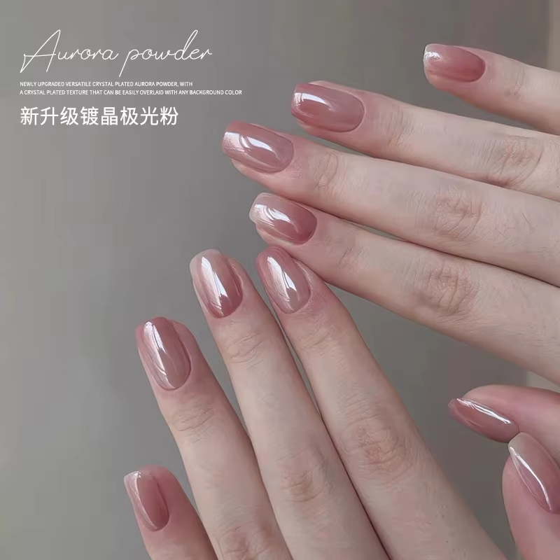 Hands with manicured nails painted with glossy, translucent pink polish that has a reflective, iridescent quality.